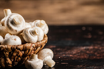 Sticker - A full basket of mushrooms on the table.