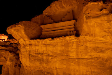 Tombs at the Mada'in Saleh (Hegra) archeological site lit up after dark, north west Saudi Arabia