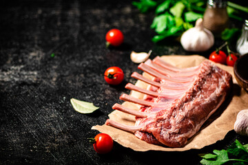 Canvas Print - Raw rack of lamb with parsley and tomatoes. 