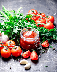 Poster - Tomato sauce in a glass jar with parsley and garlic. 