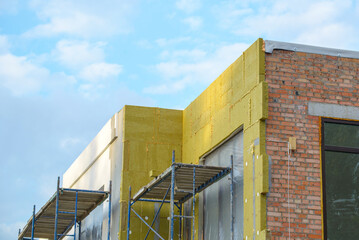 view of construction worker in doing insulation of wall at construction site