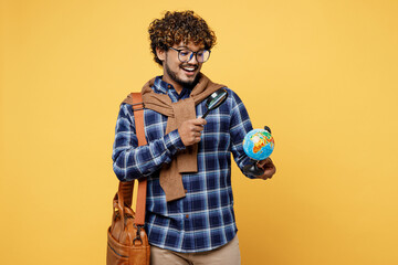 young smiling teen indian boy it student he wear casual clothes glasses bag hold globe earth map use
