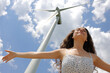 © Antonioguillem - Woman outstretching arms under a windmill