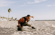 © Westend61 - Sportsman exercising with ball on beach under sky