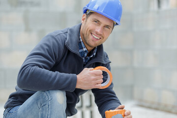 Wall Mural - happy construction worker looking at camera