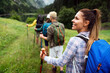 © NDABCREATIVITY - Hiking with friends is so fun. Group of young people with backpacks together