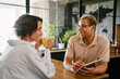 © Drobot Dean - Two smiling colleagues with tablet talking during coffee break in office kitchen