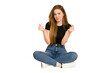 © Asier - Young redhead woman sitting on the floor cut out isolated showing that she has no money.