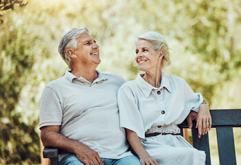 Canvas Print - Love, retirement and couple on bench in park with smile, relax and bonding time in nature together. Romance, senior man and retired woman sitting in garden, happy people and romantic summer weekend.