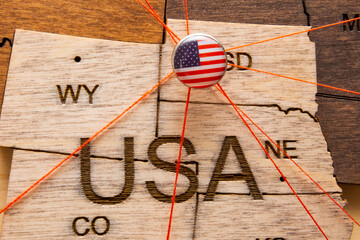Wall Mural - XXX flag on the pushpin with red thread showed the paths of movement or areas of influence in the global economy on the wooden map. Planning of traveling or logistic concept. Network connection. 