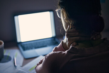 Mockup, screen and student tired at night, focus and notes for test, studying and education. Woman, female and academic with laptop light, pain in neck and revision in the evening, dark and computer