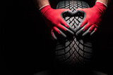 Fototapeta Kawa jest smaczna - Car tire service and hands of mechanic holding new tyre on black background with copy space for text
