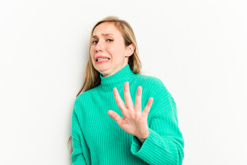 Wall Mural - Young caucasian woman isolated on white background being shocked due to an imminent danger