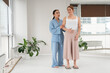 © Михаил Решетников - Caucasian woman stands on sadhu boards with therapist support.