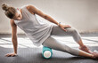 © Jordan C/peopleimages.com - Fitness, physio massage and woman with roller on floor for leg tension and support in yoga workout at gym. Health, pilates and massaging for sports physiotherapy, girl on ground foam rolling muscle.
