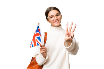 Sticker - Teenager student caucasian girl holding an United Kingdom flag over isolated background happy and counting three with fingers