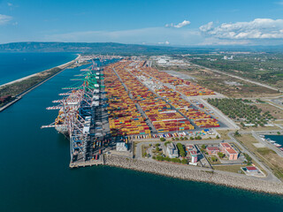 Aerial view of the port of Gioia Tauro, Calabria Italy. Goods loading and unloading operations. Container. Import and export. Global trade. Movement of goods by ship. Transportation. 31-08-2022