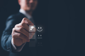 feedback Customer service satisfaction survey concept.Business people or customers show satisfaction by ticking mark on face emoticon smile in satisfaction on virtual touch screen.