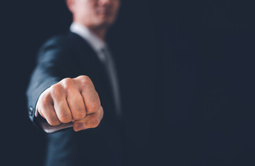 businessman clenched fist and punching forward in the concept of fighting for success in business's 