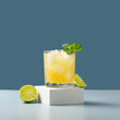 Glass of lime lemonade. Summer refreshing lemonade drink or alcoholic cocktail with ice, mint, lime and orange juice.