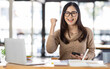 © David - Portrait of Happy Excited young asian woman at workplace office desk, successful Asian female reading good news technology online, employee freelance finance concepts.