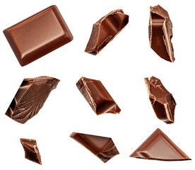  Levitating milk chocolate chunks isolated on white background. Flying Chocolate pieces, shavings and cocoa crumbs Top view. Flat lay.