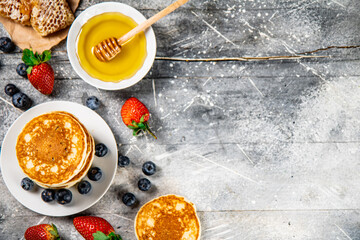 Wall Mural - Pancakes in a plate with berries and honey. 