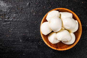 Poster - Mozzarella cheese in a wooden plate on the table. 