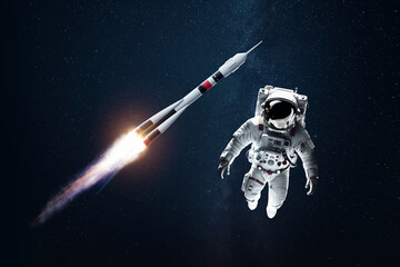 Wall Mural - astronaut in a white spacesuit in space against the backdrop of a rocket. exploration of space and o