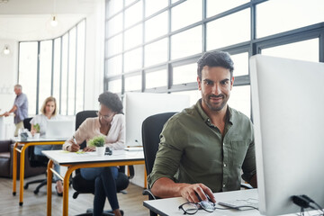 Fototapete - Designer, portrait or business man on computer in building office for research, company strategy or communication. Startup, smile or employee with tech for social network, creative planning review