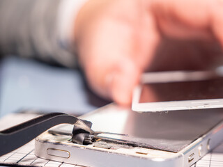 Wall Mural - A technician repairs a smartphone in a laboratory with copy space. concept of computer hardware, mobile phones, electronics, repair, upgrade and technology.