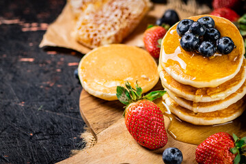 Sticker - A bunch of pancakes with berries and honey. 