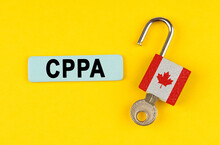 On The Yellow Surface Is An Open Lock With A Key And A Sticker With The Inscription - CPPA