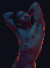 naked, art and freedom with a model asian man in studio on a dark background for artistic body posit