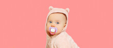 Portrait Of Cute Little Baby In Soft Costume With Pacifier On Pink Background