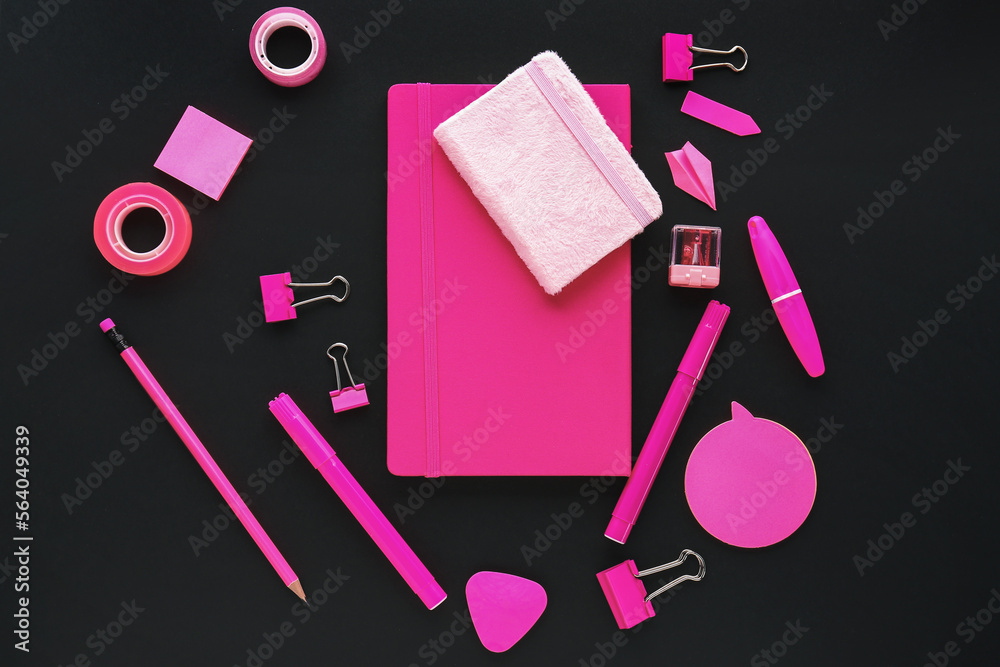 Set of colorful stationery with notebooks on dark background