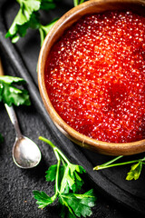 Canvas Print - Red caviar in a plate on a cutting board with parsley. 