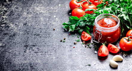 Poster - Tomato sauce in a glass jar with parsley and garlic. 