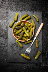 Canvas Print - Delicious pickles cooked at home. On a black background.