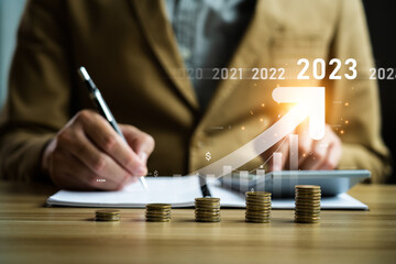Interest rate and dividend concept, businessman calculating income and return on investment in 2023. income, return, retirement, compensation fund, investment,dividend tax,stock market, trend,strategy