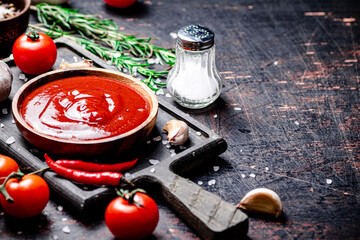 Sticker - Tomato sauce on a cutting board with red pepper, garlic and rosemary. 