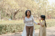 © NanSan - Portrait of asia grandmother and grandchildren holiday vacation together in the park in the summer in Southeast Asia Pacific.