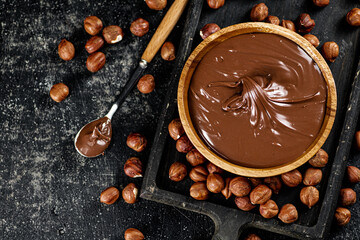 Canvas Print - Hazelnut butter on a cutting board with a spoon. 