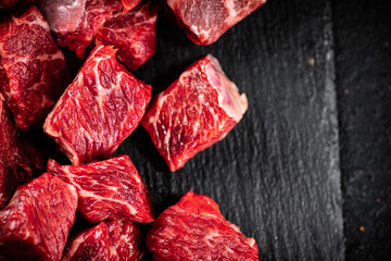 Sticker - Pieces of raw beef on a stone board. 