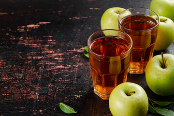 Fresh apple juice. Against a dark background.