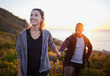 © Nina/peopleimages.com - Hiking, fitness and interracial couple exercise in sunset on a mountain as a morning workout in nature. Happy people, man and woman in a relationship training for health and wellness together