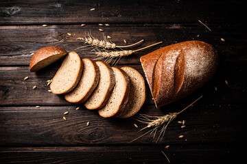 Poster - Slices of sliced bread on a table with a spike. 