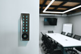Fototapeta Uliczki - Electronic digital door lock on white office wall
