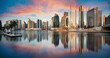 Dubai skyline with reflection at dramatic sunset,  UAE