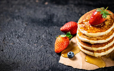 Sticker - A pile of pancakes with berries and honey. 